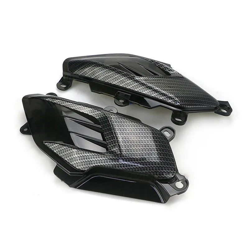 Pair of YAMAHA NMAX side replacement lamps with LED lights and carbon fibre pattern, showing blue illumination option.