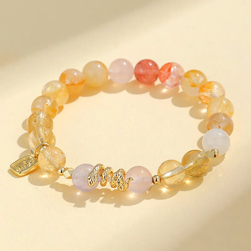 Women's crystal bead bracelet with lucky snake charms and colourful plastic flower accents