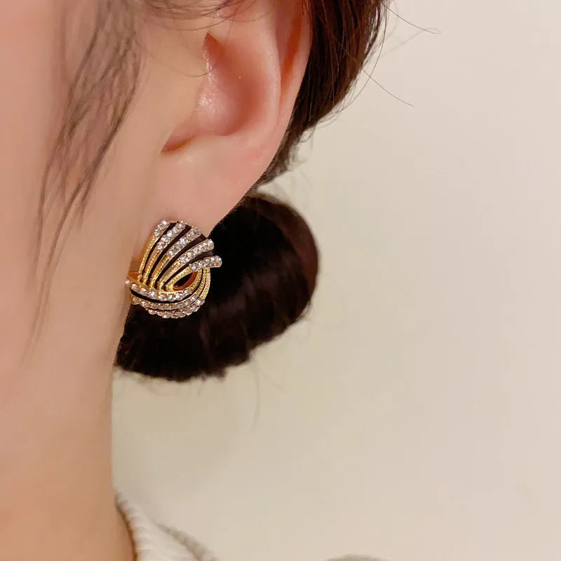 Gold plated rhinestone stud earrings with geometric ring shape and super-flash finish