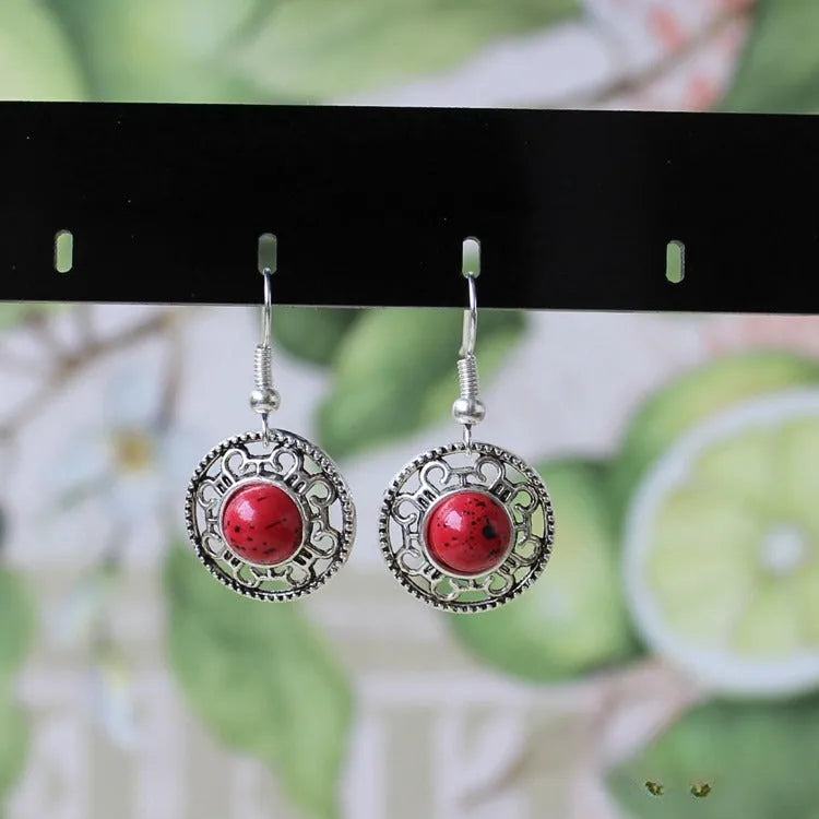 Handmade Miao silver ethnic earrings with turquoise on a retro flower disk design.