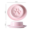 Green ceramic slow feeder pet bowl with raised centre and non-slip base.