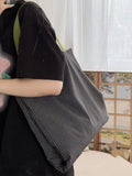 Canvas tote shoulder bag with plaid print design and shoulder strap