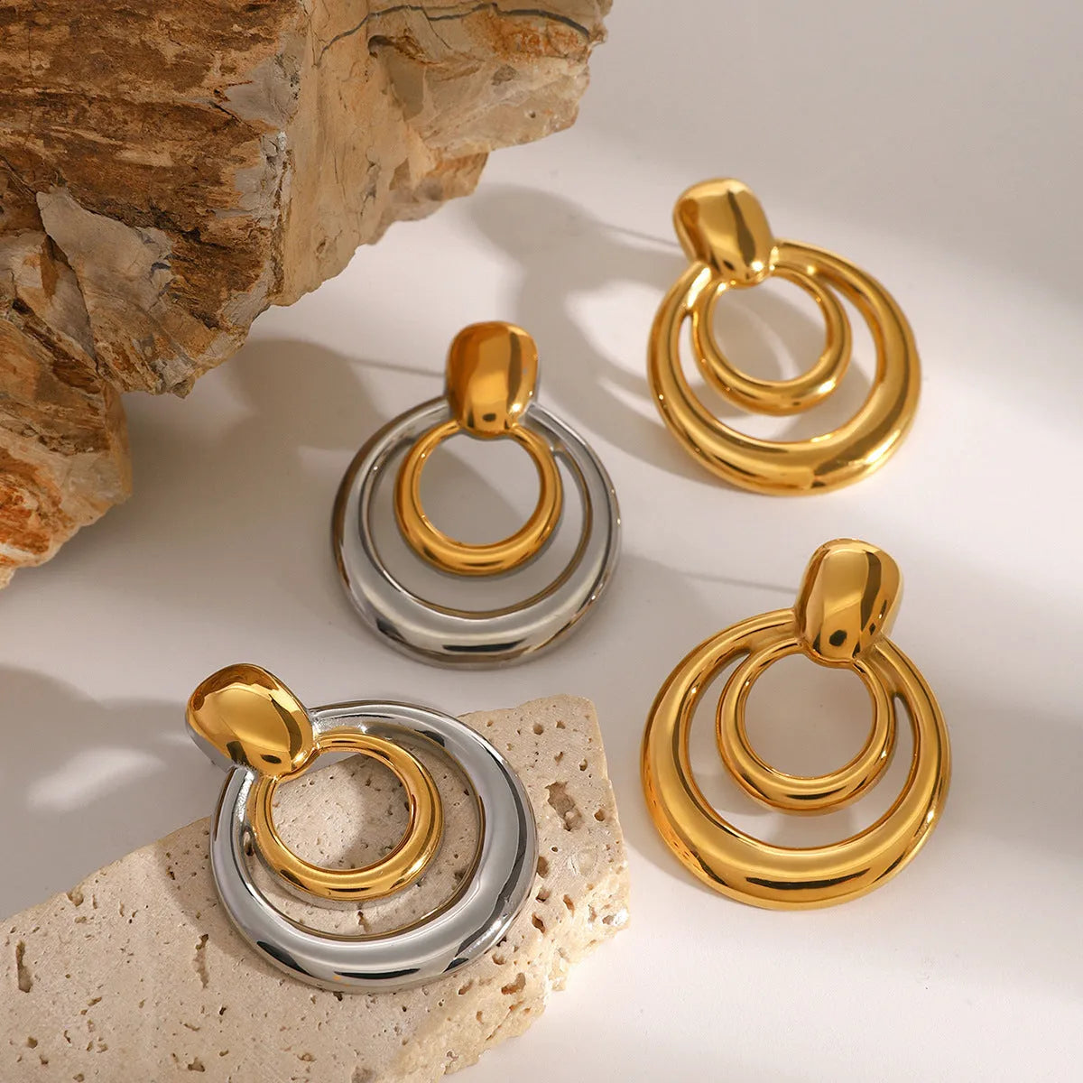 Golden titanium steel round stud earrings with double-layer hollow geometric design
