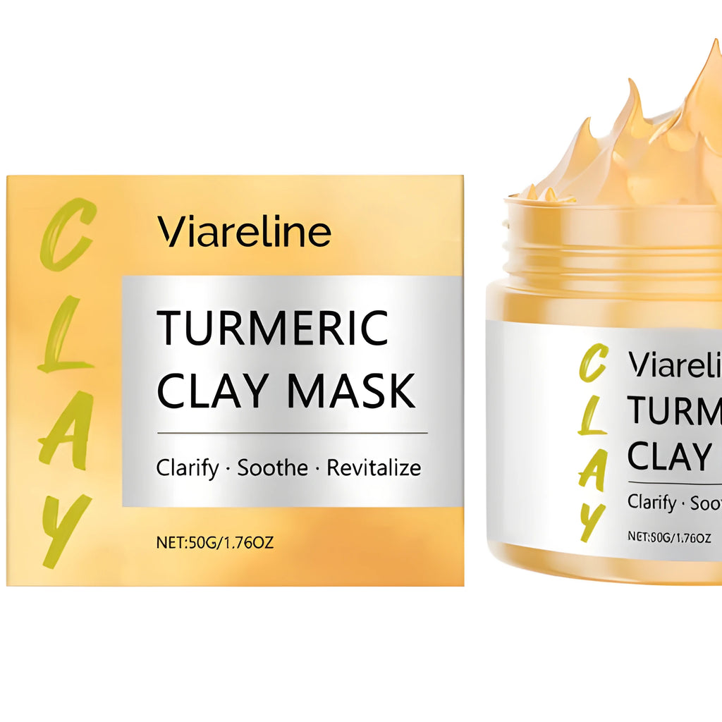 Yellow turmeric mud facial mask with application brush on wooden surface