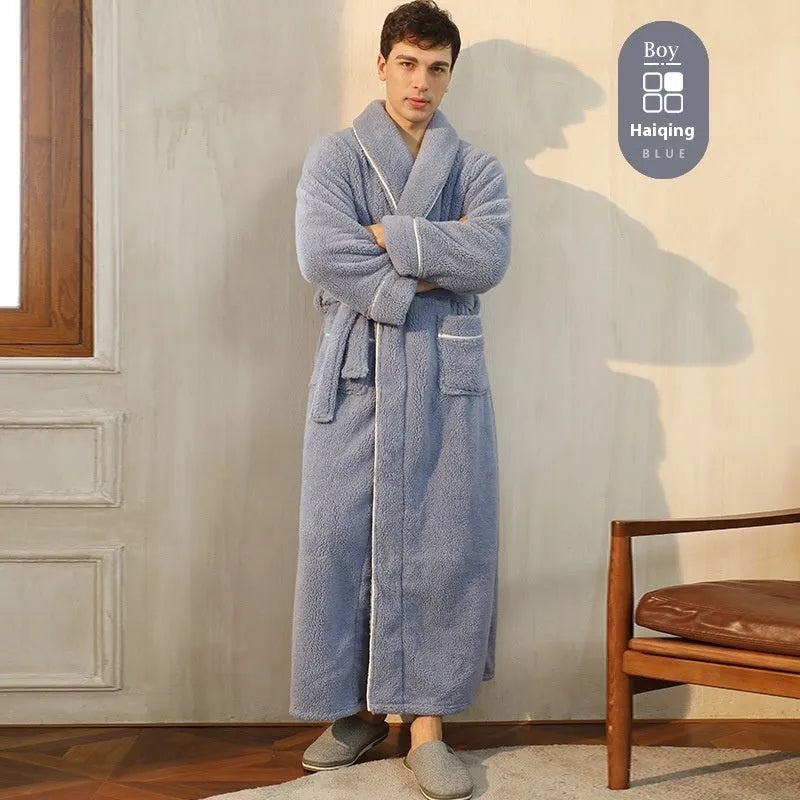Man and woman wearing matching thick navy blue flannel bathrobes, showcasing the couple's winter loungewear.