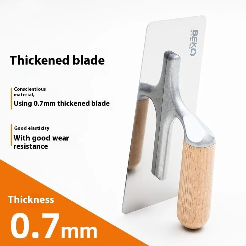 Stainless steel putty scraper with a wooden handle in three different blade sizes on a workbench.