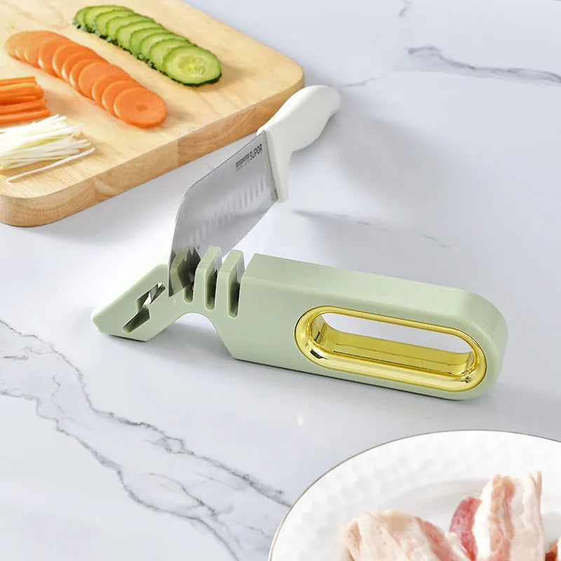 Four-in-one stone manual grinder for sharpening kitchen knives in pearl white colour, with ceramic and diamond stages visible