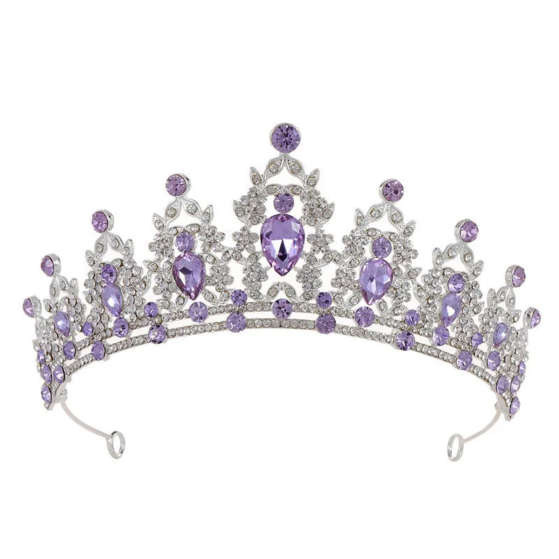 A silver and rhinestone baroque bride crown headdress with intricate detailing on a white background.