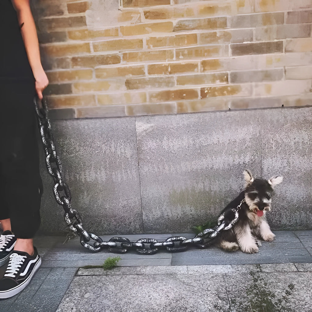 Large bronze coloured plastic dog leash prop on a white background.