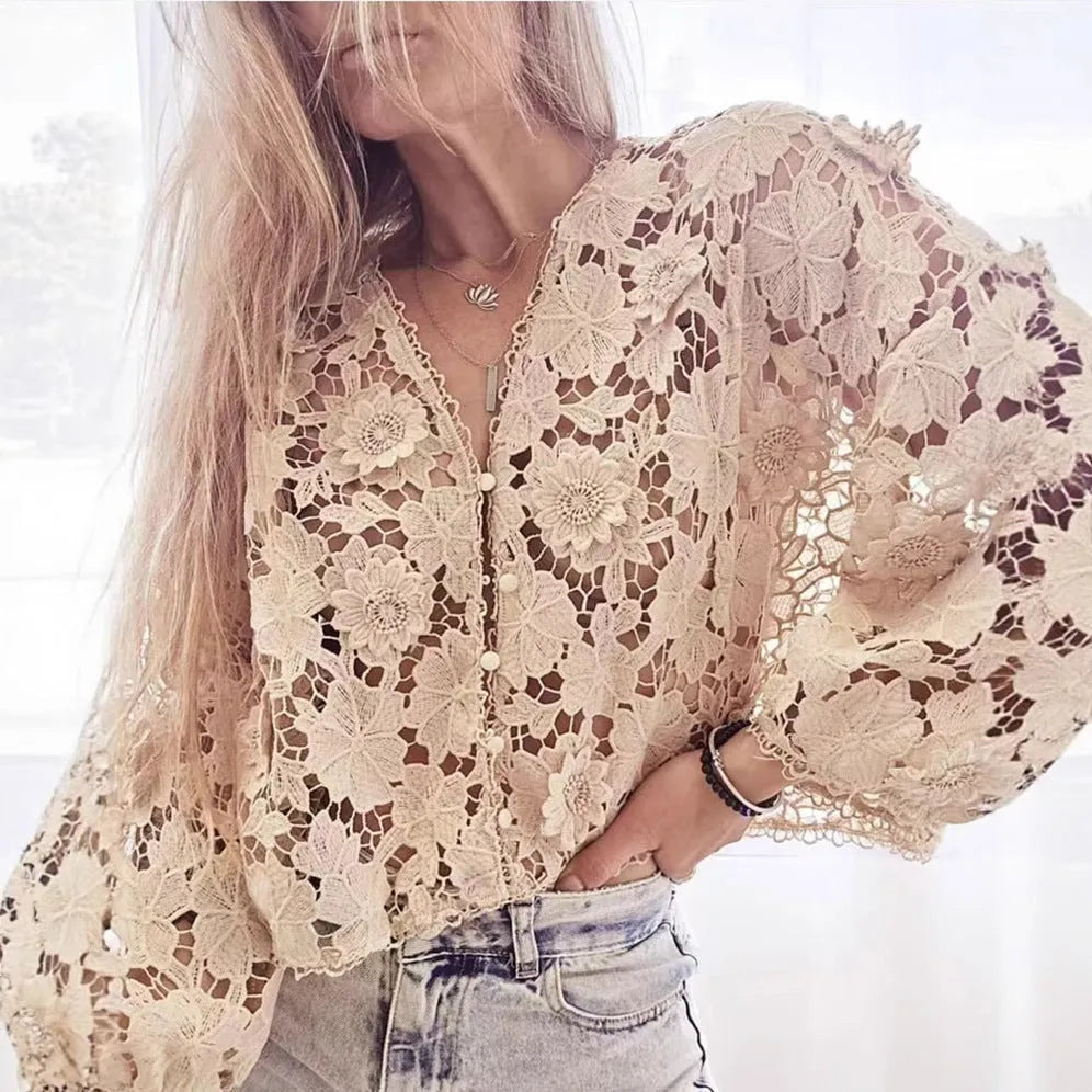 Loose-fit black lace cardigan with 3D flower detailing on a model, showing V-neck and long sleeves.
