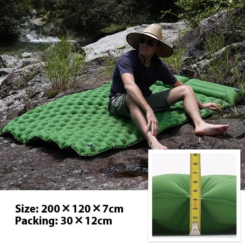Double camping air mattress inflated, showing widened design and colour options including army green and dark blue.