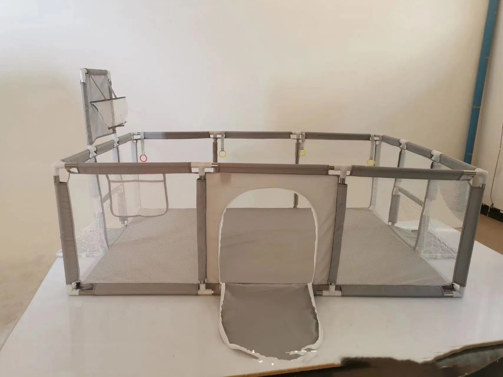 Large blue children's playpen tent with stainless steel frame and Oxford cloth walls set up indoors.
