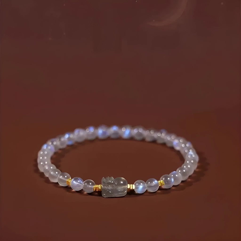 Polished moonstone bracelet with animal/Zodiac design on an adjustable cord for women.