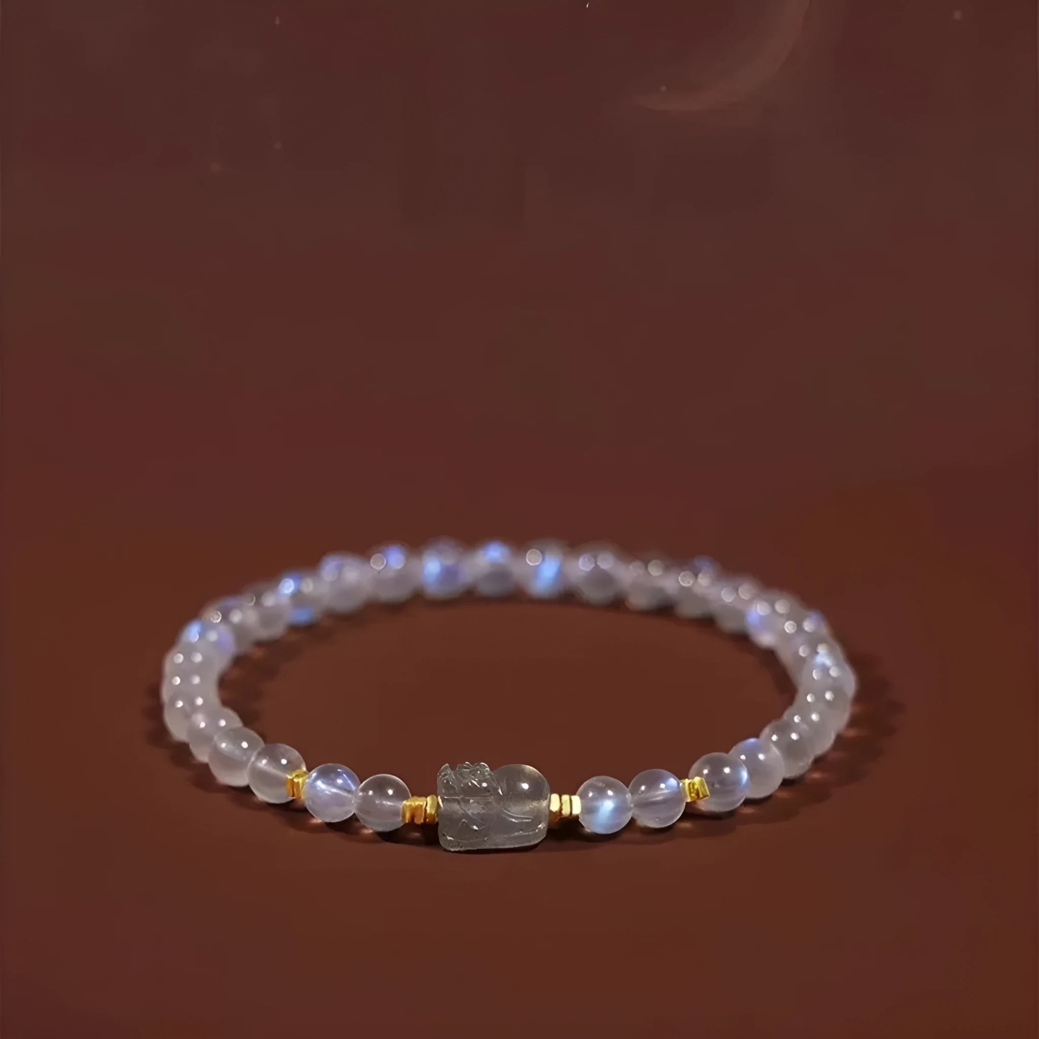 Polished moonstone bracelet with animal/Zodiac design on an adjustable cord for women.