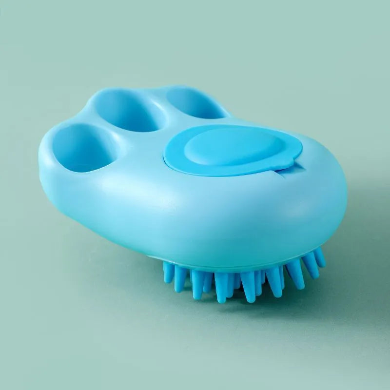 Blue silicone claw-shaped pet bath brush with flexible bristles for washing cats and dogs.