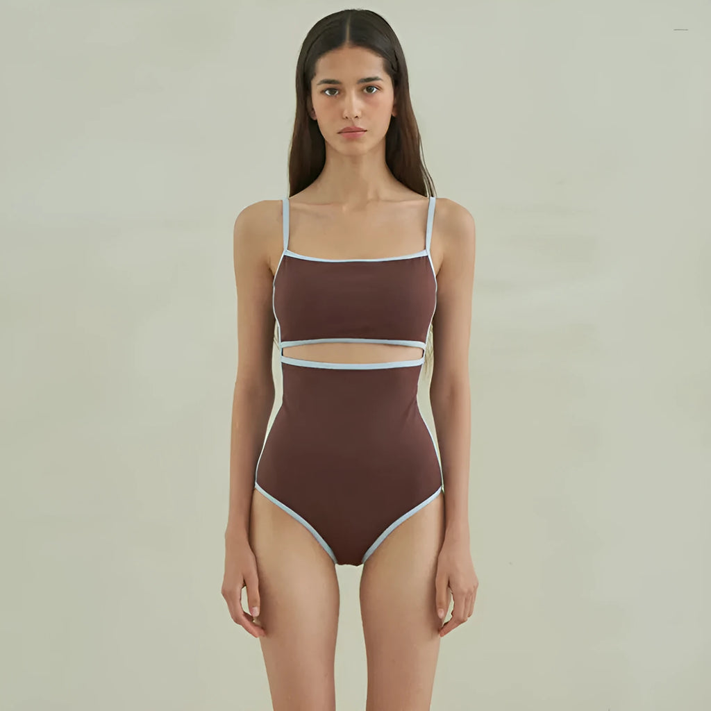 Brown women's one-piece triangle swimsuit on a hanger, showing nylon fabric texture.