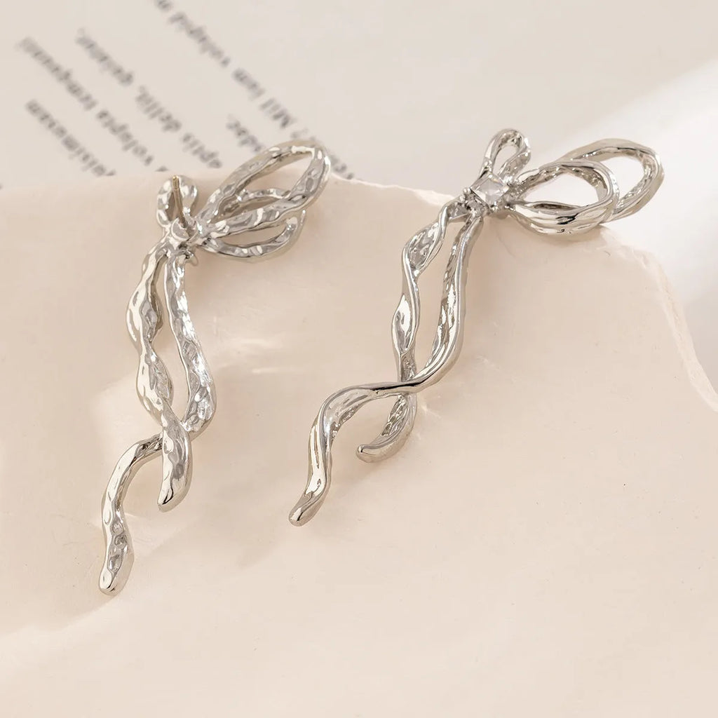White K bowknot earrings for women, alloy electroplated bow-shaped earrings, one pair