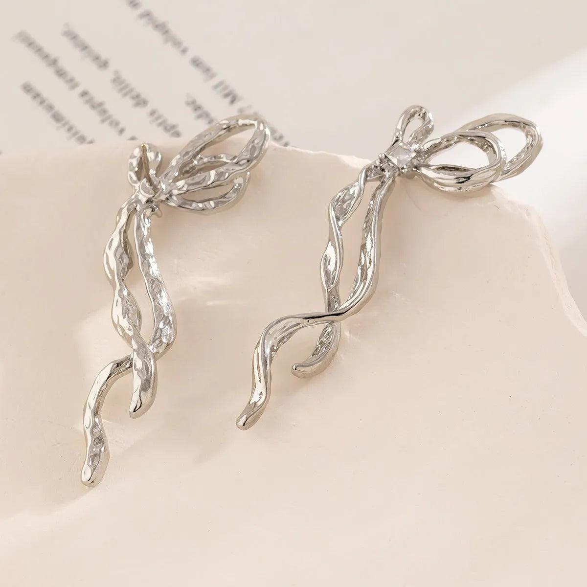 White K bowknot earrings for women, alloy electroplated bow-shaped earrings, one pair