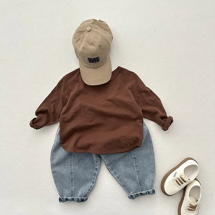 Light blue children's baggy denim jeans with elastic waistband, front view