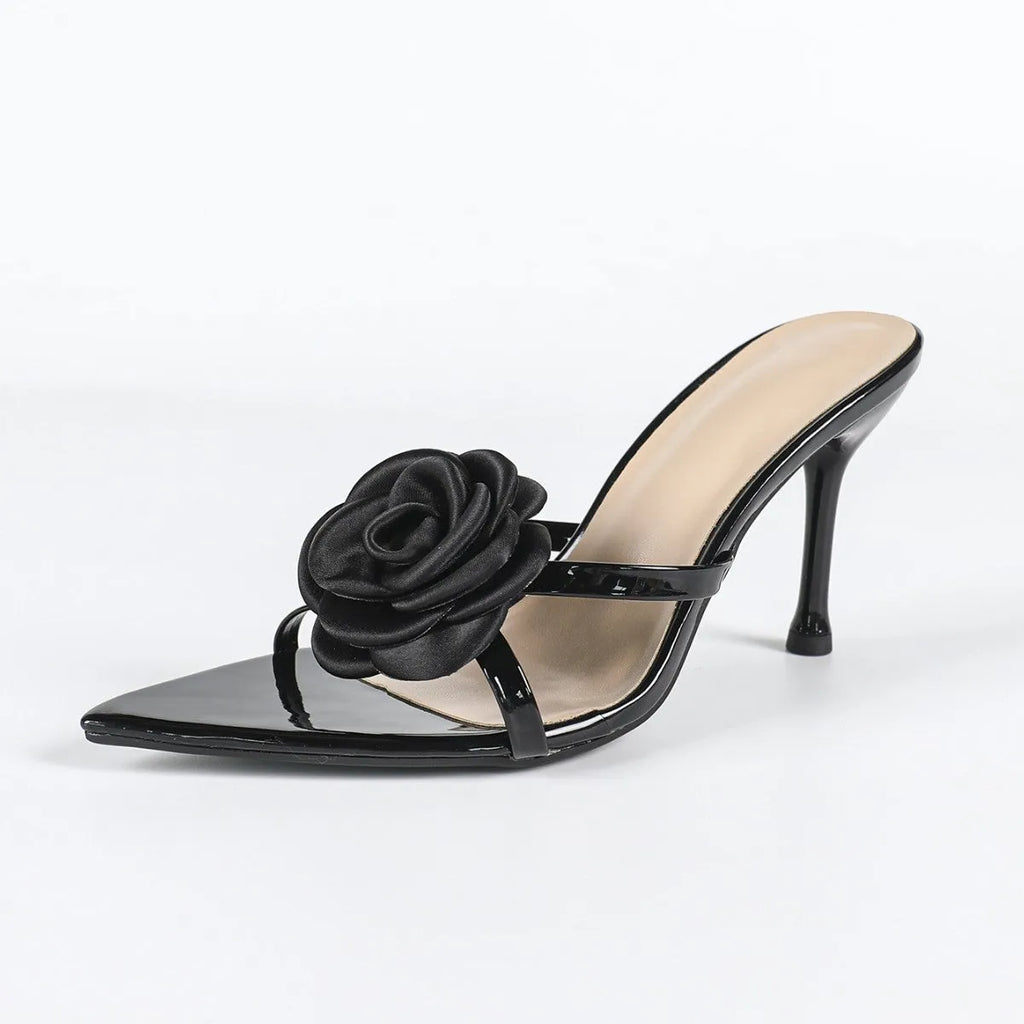 Women's black patent leather pointed stiletto sandals with 3D flower detail on upper