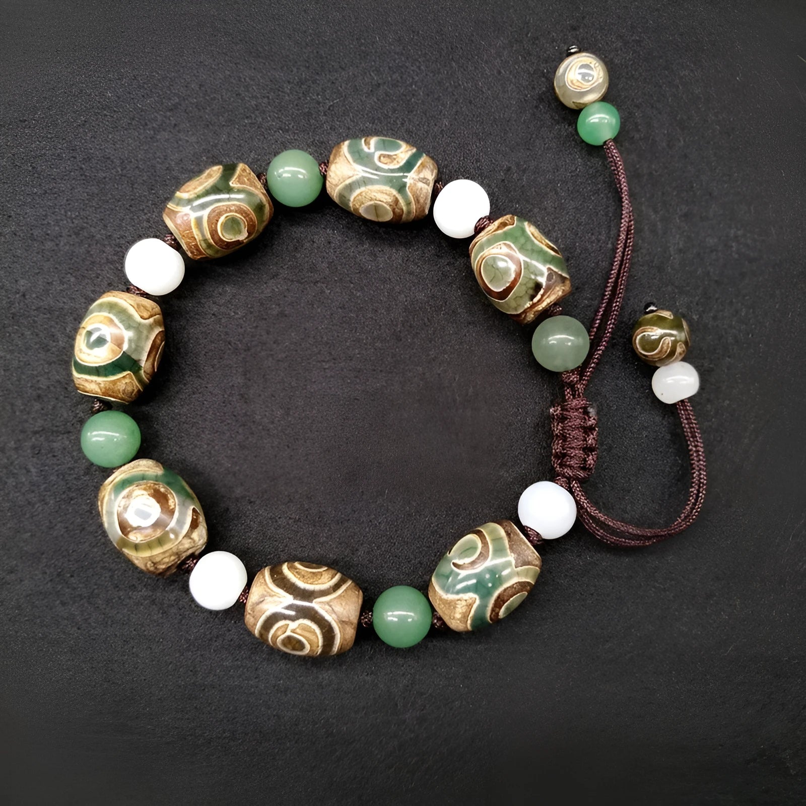 Green agate ethnic bracelet with three eye Tibet beads in hand-woven geometric pattern