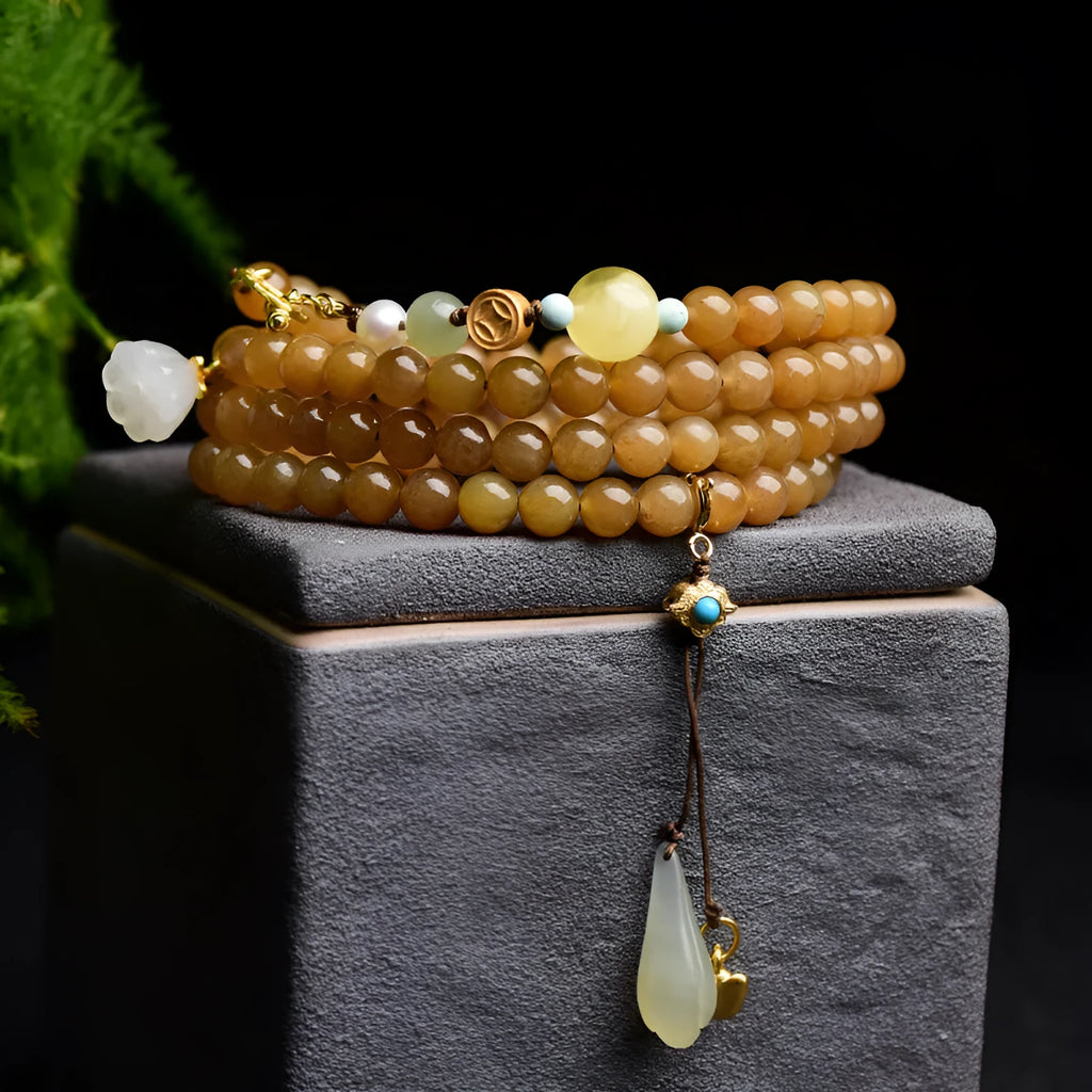 Green jade bracelet with round 6mm beads, beeswax and pine leaf charms on natural background