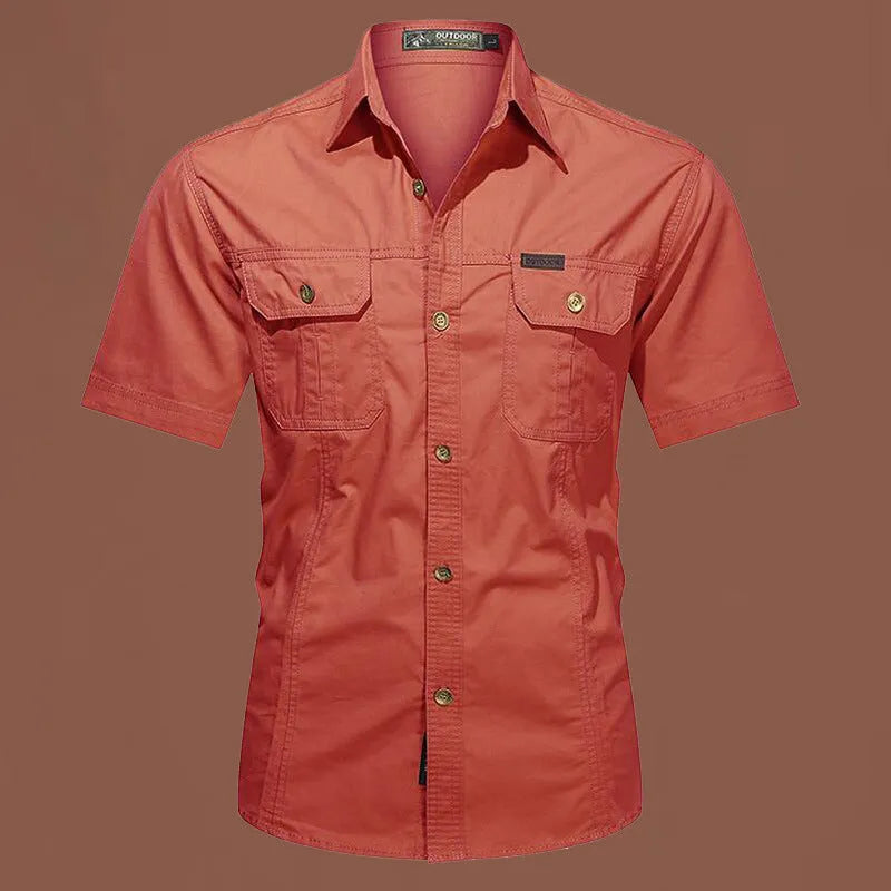Man wearing a beige cotton short sleeve work shirt with a cardigan style and loose fit.