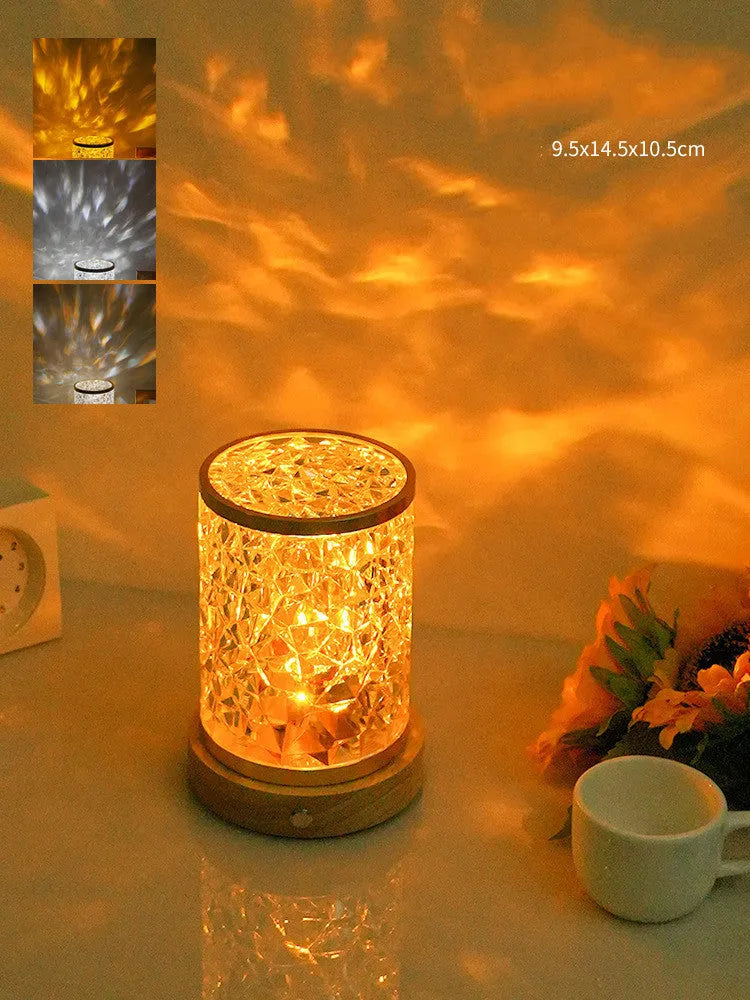 Modern rotating water ripple night light with a wooden base and touch control on a bedside table.