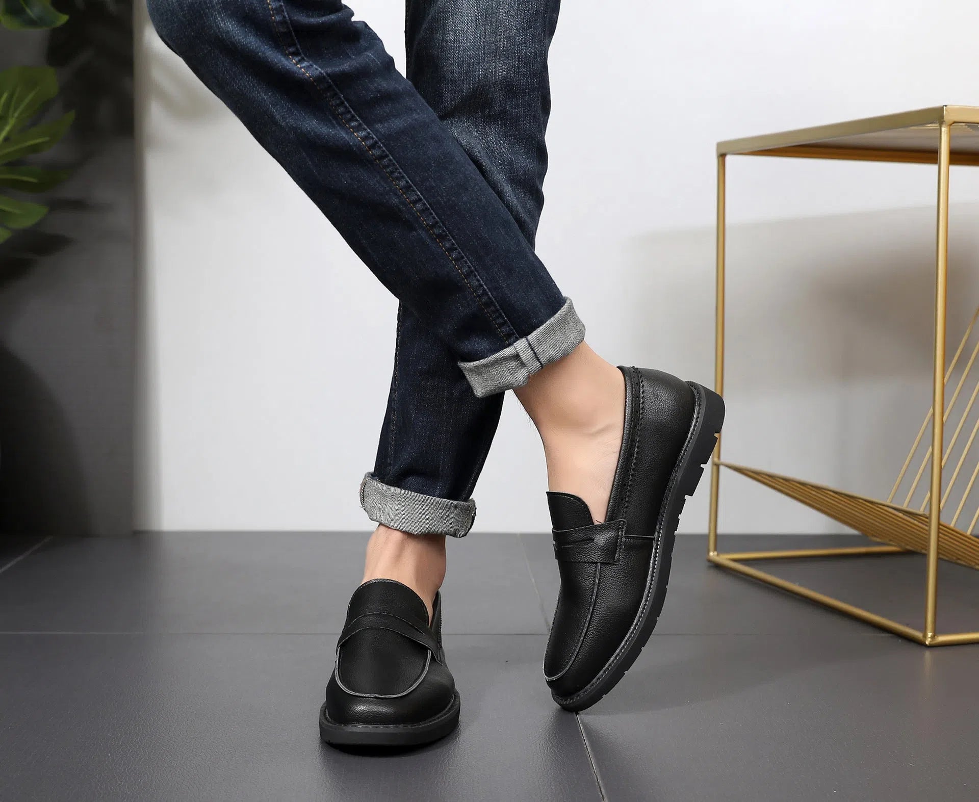 Men's black Korean retro slip-on driving shoes with microfiber upper and stitched detailing on white background