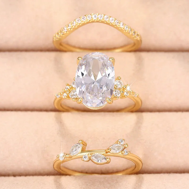 Copper zircon ring set with goose egg-shaped cut in Q681 gold on hand, three rings with flower and geometry shapes