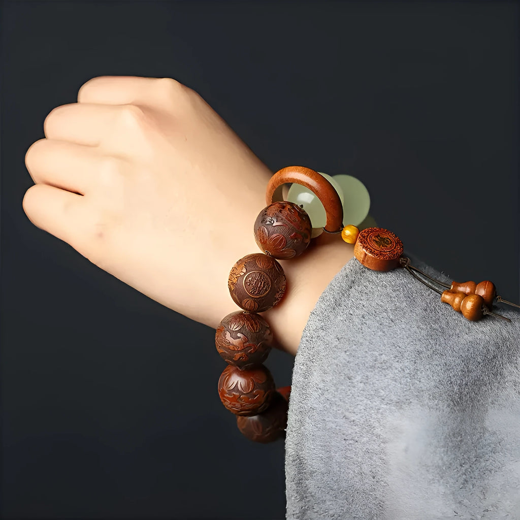 Wooden bracelet with carved Amass Fortunes character on rosewood segments