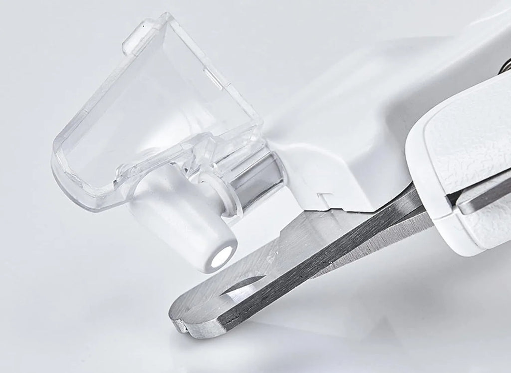 White pet nail clippers with LED light, transparent anti-splash guard, and triangular blade for cats and dogs