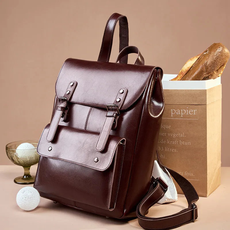 Black cowhide leather laptop backpack for women with a structured, hard-sided design.