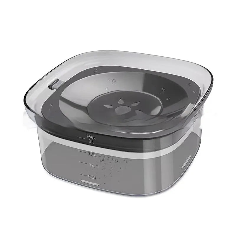 Large transparent pet water bowl with floating slow-feeder disk inside.