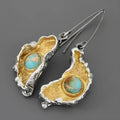 Ear-shaped women's earrings in alloy with a two-tone oil-painted geometric finish, shown as a pair