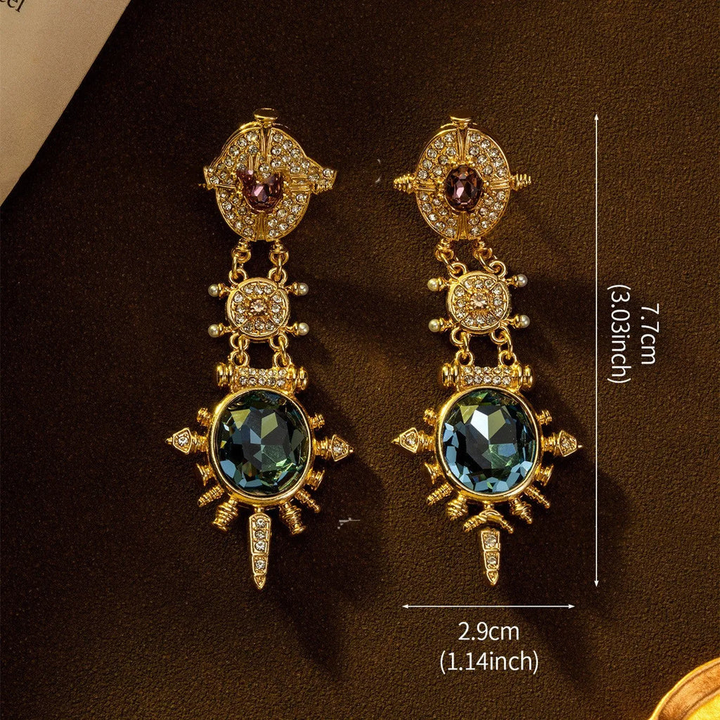 A pair of gold geometric retro-style alloy stud earrings with round diamond-treatment details.
