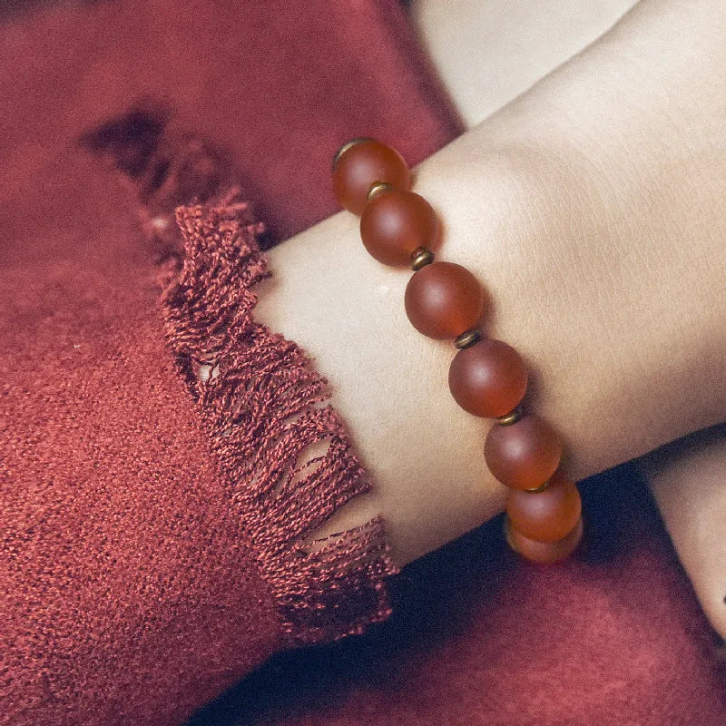 Retro ethnic style couples bracelet made from natural green agate beads on a wrist.