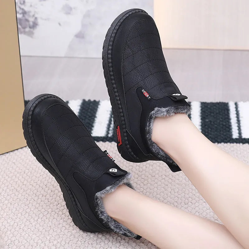 Women's black casual flat ankle boots with a synthetic leather upper and rubber sole.
