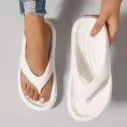 Women's black EVA flip flops with thick sole and non-slip tread on a plain background.