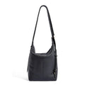 Women's large grey genuine leather bucket bag with a soft handle on a casual outfit.