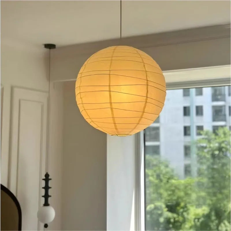 Japanese style rice paper ceiling chandelier light fixture in a living room setting.