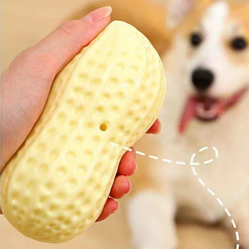 Yellow peanut-shaped dog chew toy with textured surface and squeaker