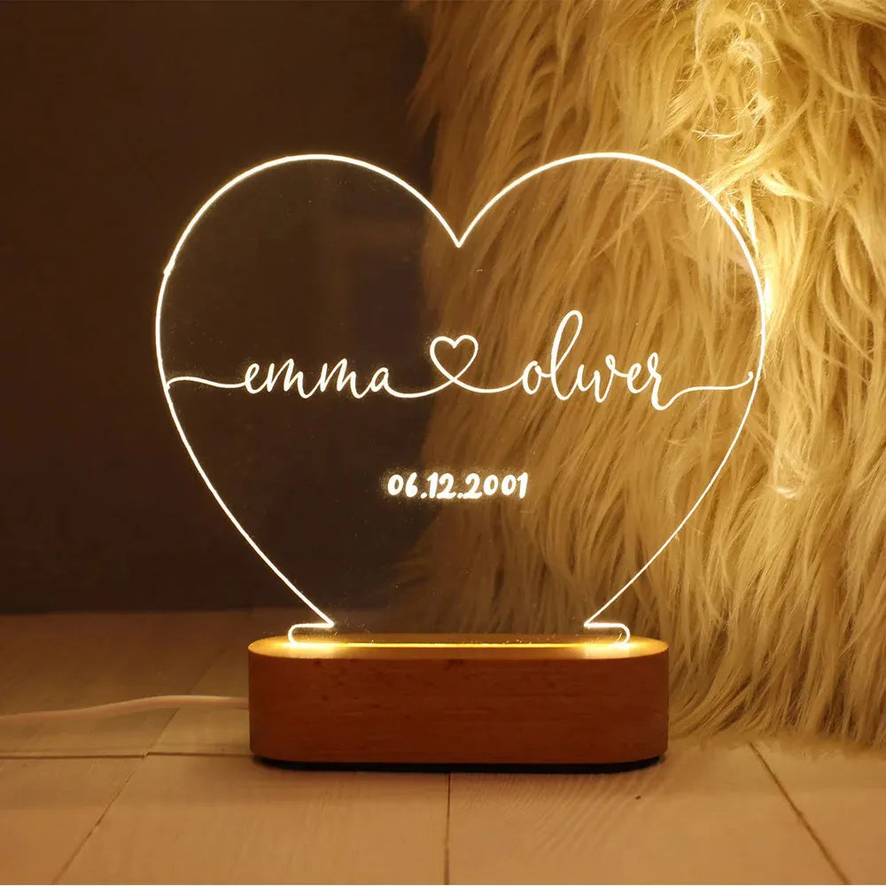 Custom transparent acrylic LED night light personalised with names and date, 20cm by 11.5cm.
