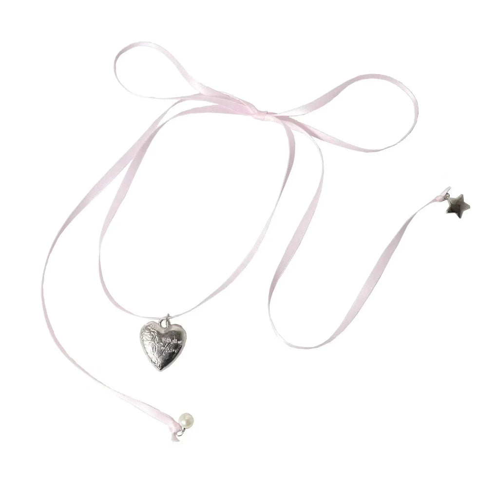 Close-up of a women's alloy fashion necklace with a ribbon love pendant on a dainty clavicle chain.