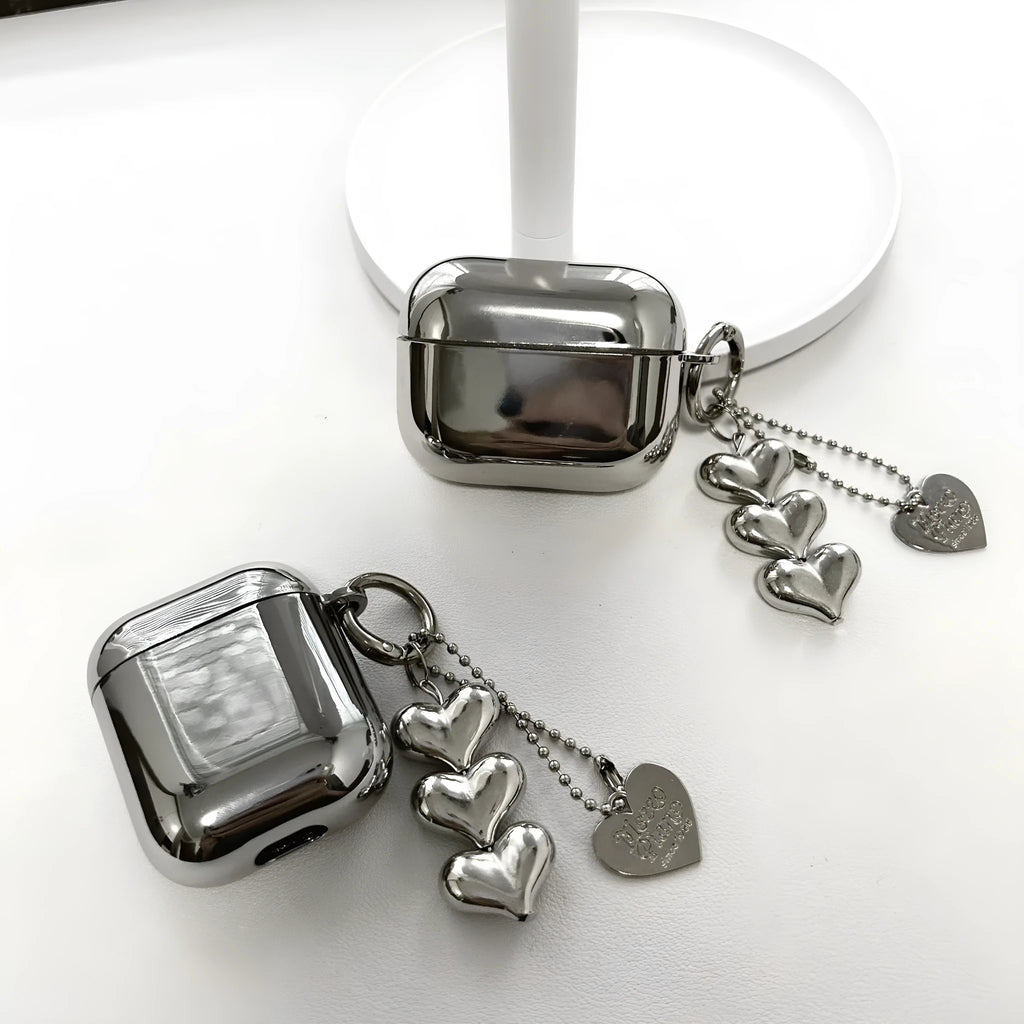 Electroplated solid colour iPhone headphone case with heart pendant attachment on a soft TPU shell.