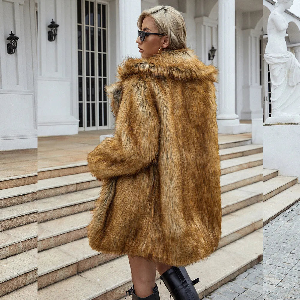 Yellow loose-fitting women's long faux fur coat on a hanger.