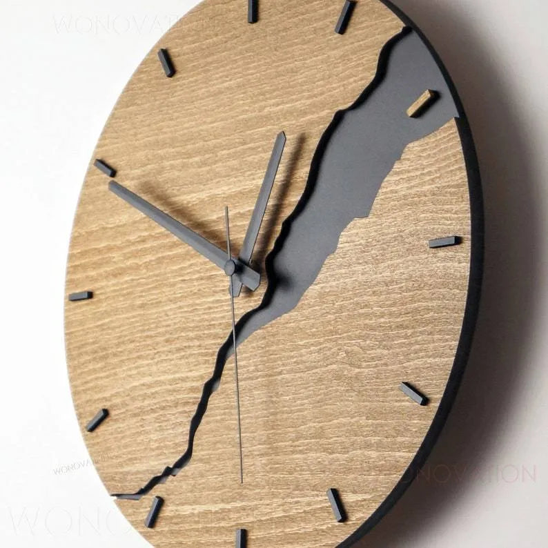 Modern wooden wall clock with a crack design on a clear acrylic face, 25 cm in diameter.