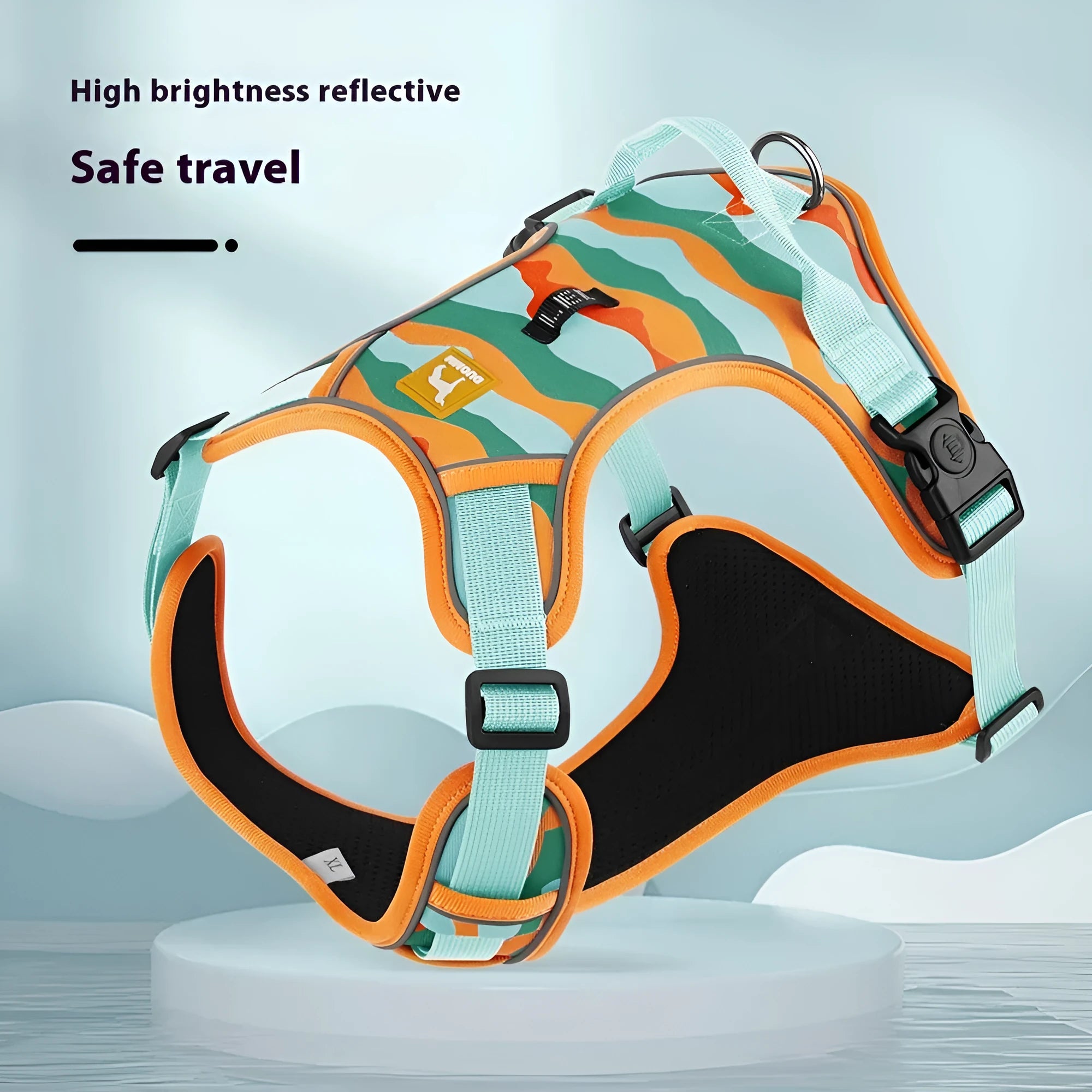 Orange reflective dog harness and hand-hold lead on a grassy background.