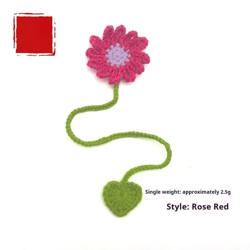 Hand-crocheted daisy bookmark made from flexible milk cotton wire in assorted colours on an open book.
