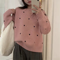 Beige women's loose knit acrylic cardigan with embroidery on the front, featuring long sleeves and a crew neck.